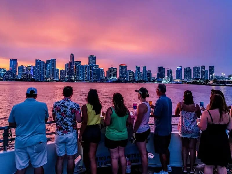 Guests watching the Miami skyline at sunset from an open-bar boat tour